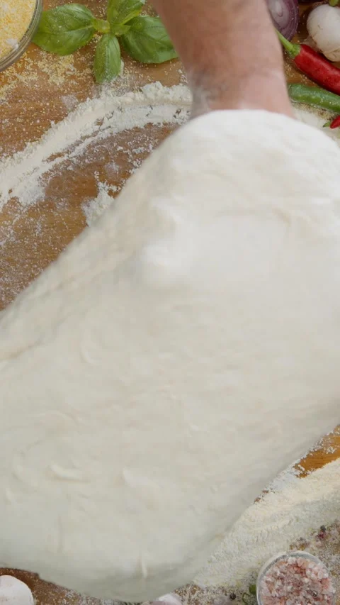 Professional chef hands kneading fresh pizza dough on wooden table top view. Stock Footage 337445679