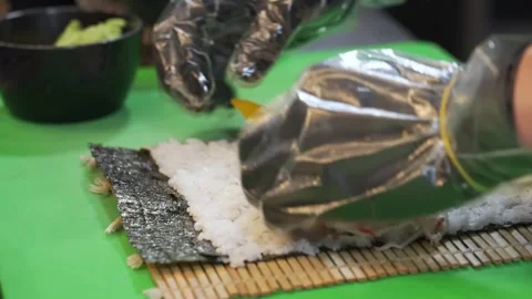 Professional Chef Hands Rolling Fresh Sushi on Bamboo Mat Stock Footage 333570339