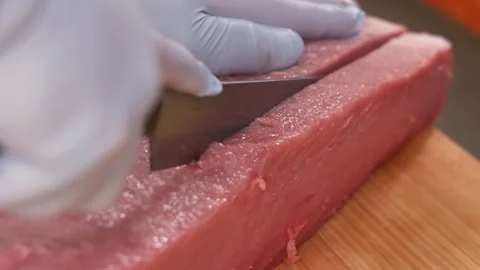 Professional Chef Hands Slicing Fresh Raw Bluefin Tuna Fillet for Sashimi and Su Stockbeeldmateriaal 333499469