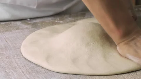 Professional Chef Hands Stretching and Forming Fresh Pizza Dough on Wooden Table Stock Footage 333522728