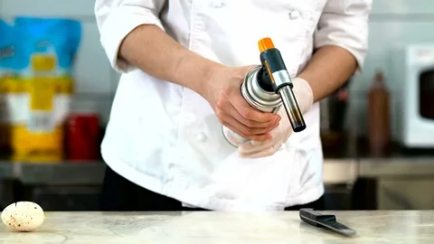 Professional chef heating the knife before cutting chocolate Stock-Footage 70308405