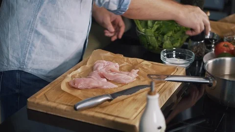 Professional chef in kitchen prepares meat, pepper, salt, pour soy sauce, fresh Stock Footage 125729535