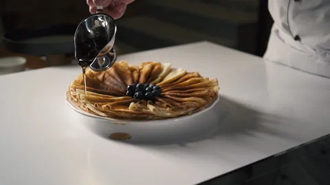 Professional Chef in Kitchen of Restaurant pours Pancakes honey or maple syrup. 스톡 동영상 143416160