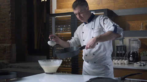 Professional Chef in the Kitchen of Restaurant prepares Pancakes. Slow motion 스톡 동영상 143416064