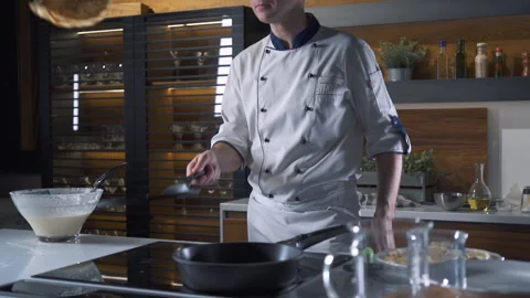 Professional Chef in the Kitchen of Restaurant Tossing Pancakes in Pan. 動画素材 143416085