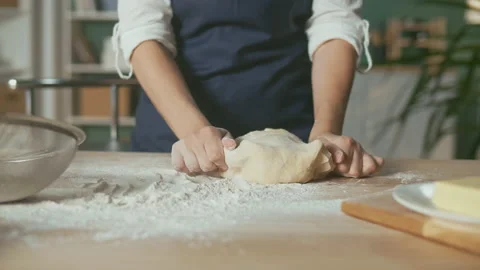 Professional Chef Kneads Dough for Baking on a Wooden Kitchen Table. Stock Footage 156570995