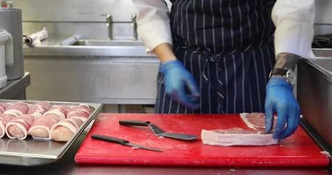 Professional Chef laying out bacon on a board Stock Footage 289411023