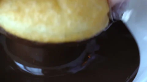 Professional chef lets down freshly made and oily doughnut in deep capacity with Stock Footage 199489236