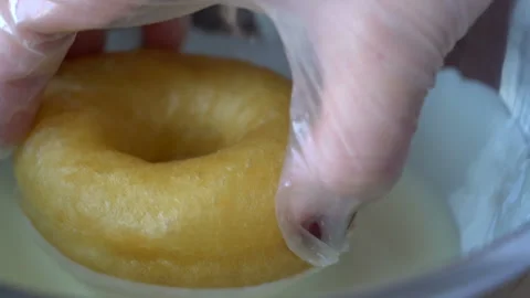 Professional chef lets down freshly made and oily doughnut in deep bowl filled w Stock Footage 199489243