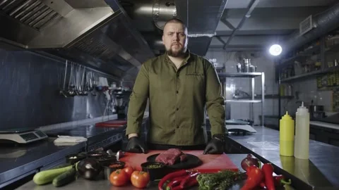 A professional chef is looking at the camera before cooking. Stock Footage 230703662