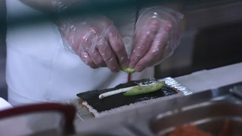 Professional chef makes a roll with avocado and fish Stock Footage 87641804