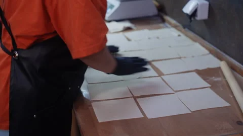 Professional chef making dumpling wrappers in restaurant kitchen Stockbeeldmateriaal 323097569