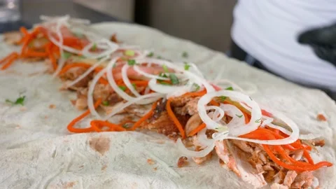 Professional chef is making shawarma at fast food cafe, close-up Stock Footage 150483207