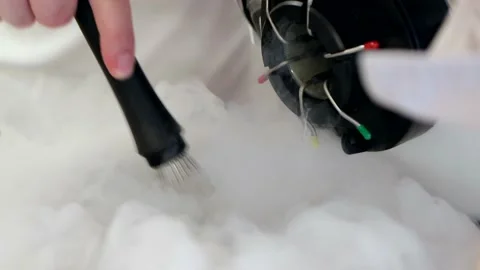 Professional chef is mixing ingredients with liquid nitrogen in steel bowl Stock Footage 189909264