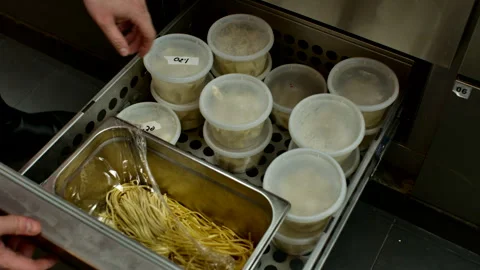Professional Chef Opening Kitchen Storage Drawer with Prepped Pasta Video stock 328798299