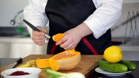 Professional chef is peeling a pumpkin. Video stock 88943084