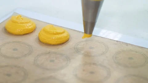 Professional Chef Piping Bright Yellow Mango Fruit Puree Onto Macaron Template S Stock Footage 343019616