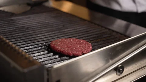 Professional chef placing raw minced meat patty for a burger Stock Footage 338391070