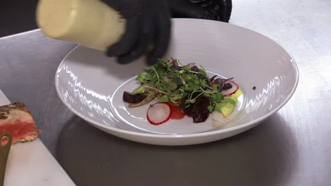 Professional chef plates salad on sashimi Stock Footage 167144376