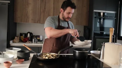 Professional chef plating a meal in a modern kitchen Stock Footage 340224059