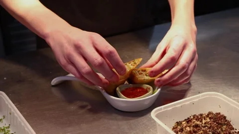 Professional chef plating spring rolls in restaurant kitchen, culinary Stock Footage 346924677