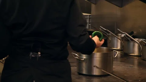 Professional Chef Pouring Beer Ingredient into Stew Pot in Restaurant Kitchen Stock Footage 343842991