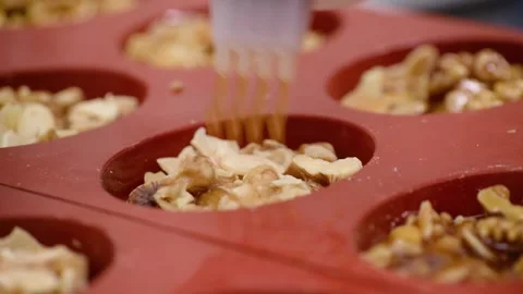 Professional Chef Pouring Golden Syrup into Mini Almond Pie Silicone Molds Stock Footage 337751601