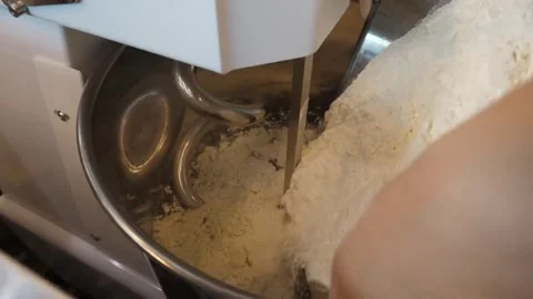Professional Chef Pouring White Flour into Industrial Spiral Mixer for Authentic Video stock 337676568