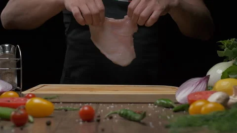 A professional chef prepares the chicken steak before frying. Slow motion. Stock Footage 138588436