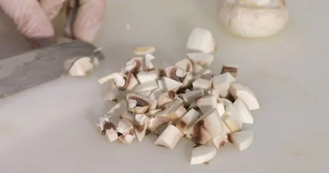 Professional chef prepares a dish, slices mushrooms Stock Footage 145561259