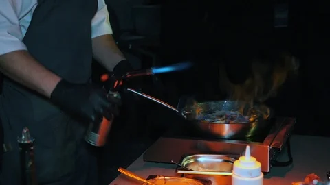 Professional chef prepares a fruit dessert with alcohol Stock Footage 102225854