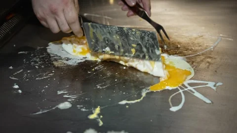 A professional chef prepares an omelet made from fresh farm eggs, fried eggs in Video stock 277254125