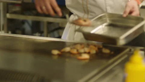 A professional chef prepares shrimp in the restaurant kitchen. Professional Stock Footage 232562509