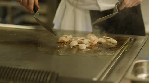 A professional chef prepares shrimp in the restaurant kitchen. Professional Stock Footage 232562576
