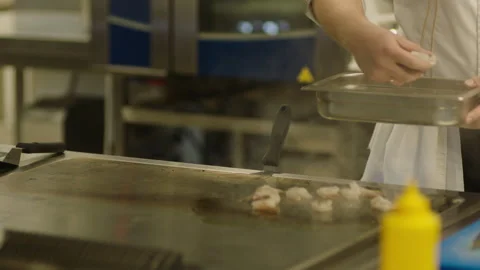 A professional chef prepares shrimp in the restaurant kitchen. Professional Stock Footage 232562757