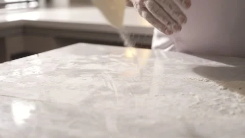 Professional chef preparing dough on a floured surface in a kitchen Stock Footage 336674384