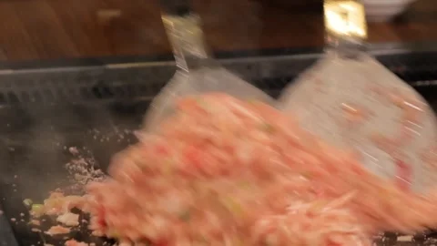 Professional Chef Preparing Traditional Tokyo Monjayaki on Teppan Griddle Stock Footage 333521622