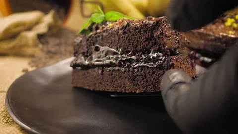 Professional chef puts the chocolate slice cake on the plate. Stock Footage 144309650