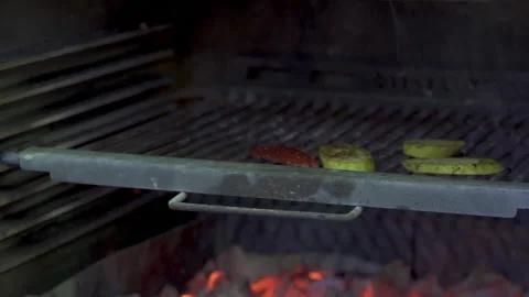 A professional chef puts vegetables in the barbecue, grill with tongs. Stock Footage 153383544