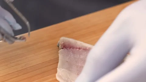 Professional Chef Removing Fish Bones from Raw Fillet for Sushi Preparation Stock Footage 333500467
