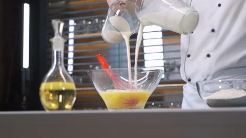 Professional Chef in Restaurant Kitchen pours milk. Delicious healthy Food. Stock-Footage 143415715
