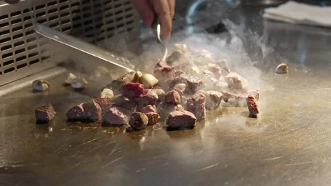 A professional chef roasts meat and mushrooms in a frying pan. Stock Footage 278403906