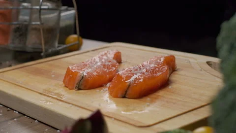 Professional chef salting red fish steak Stock Footage 140128215