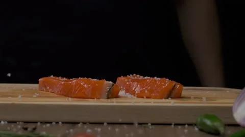 Professional chef salting red fish steak Stock Footage 205836366