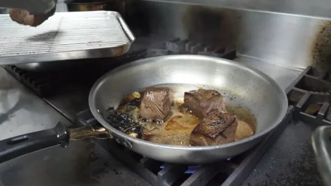 Professional Chef Searing Beef Steaks in Stainless Steel Pan – Gourmet Italian K Stock Footage 337678271