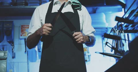 Professional chef sharpening knife in restaurant kitchen close up Stock Footage 203555423