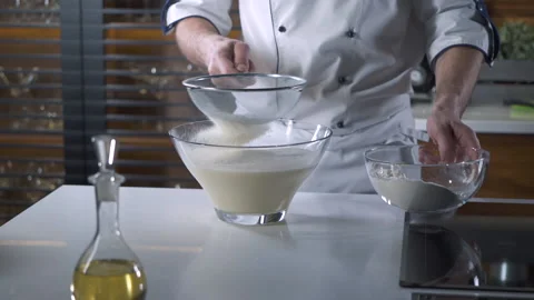 Professional Chef sifting Flour for a Baking in a Restaurant Kitchen. Vidéo 143415707