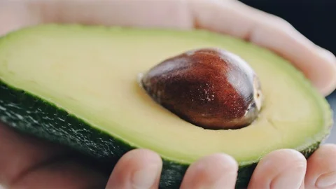 Professional chef skilfully cuts avocado Stock Footage 104720008