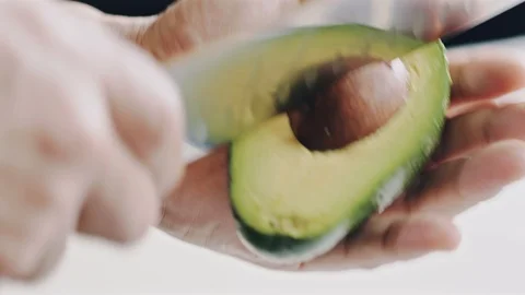 Professional chef skilfully cuts avocado Stock Footage 104720009