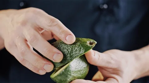 Professional chef skilfully cuts avocado Stock Footage 104720037